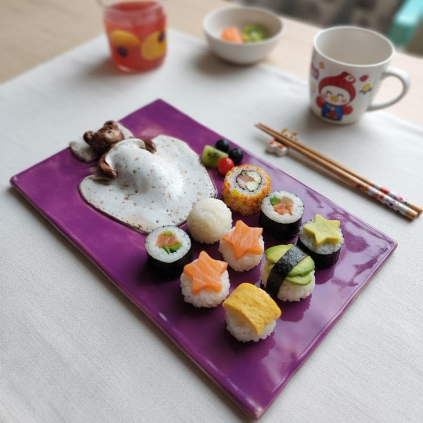 Handmade lilac purple rectangular ceramic plate featuring a 3D hand-sculpted teddy bear sleeping under a speckled white blanket with a small pillow.